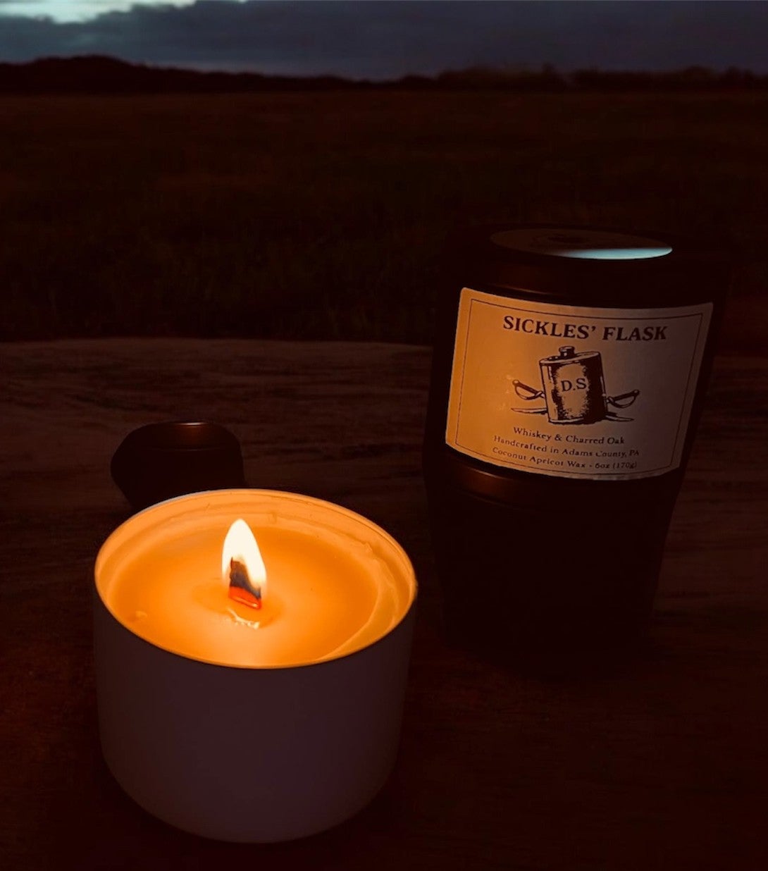 Sickles' Flask candle and bottle on a dark background