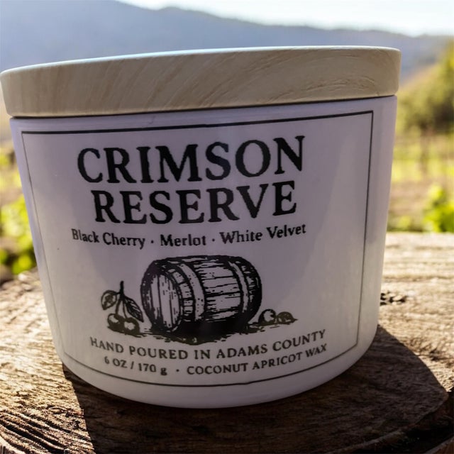 Crimson Reserve candle in a white jar with a wooden lid